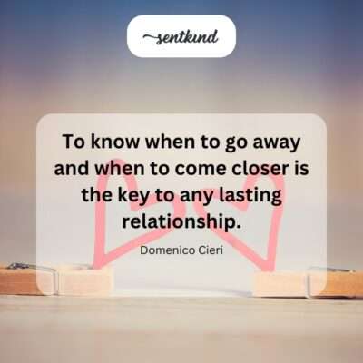 A couple stands on a path at a crossroads, one person stepping forward and the other paused behind them.