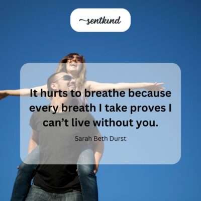 A lone figure hunches over, clutching their chest as if in pain, against a blurred, somber background.