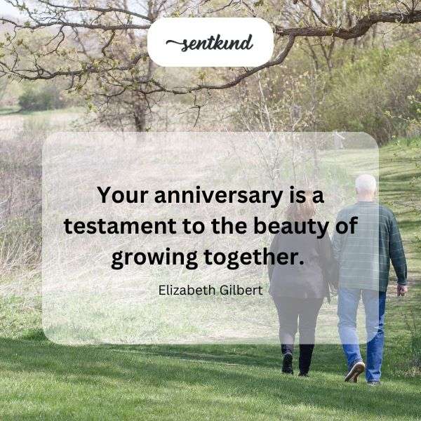 Couple holding hands while walking through a blooming garden path.