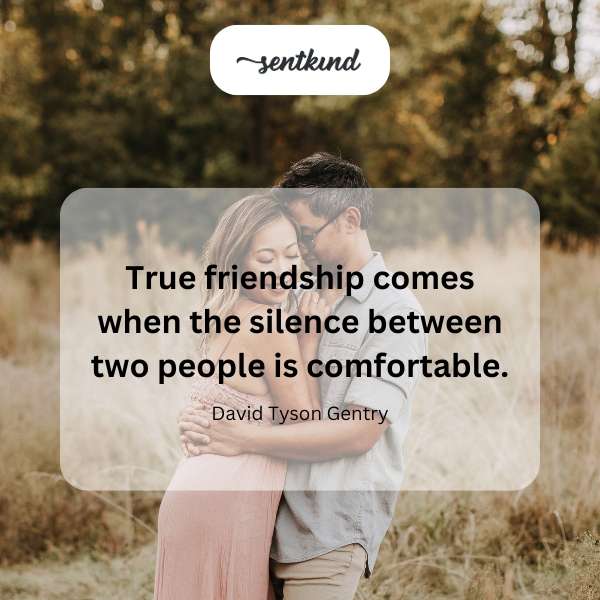Two people are sitting comfortably on a park bench, enjoying each other's company in silence.
