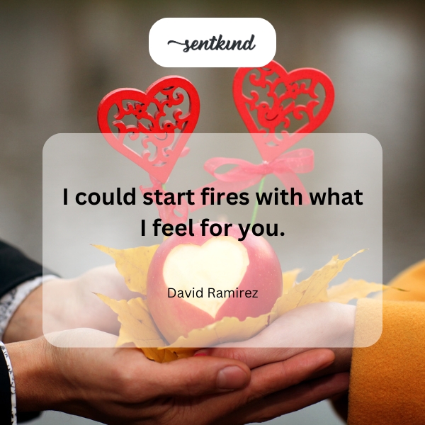 A person holds a glowing heart that emits sparks.