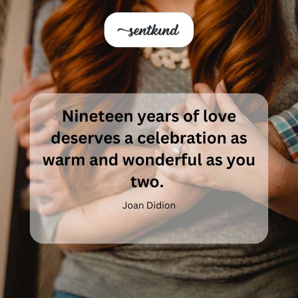 A couple embracing tenderly amidst a warmly lit, celebratory setting.