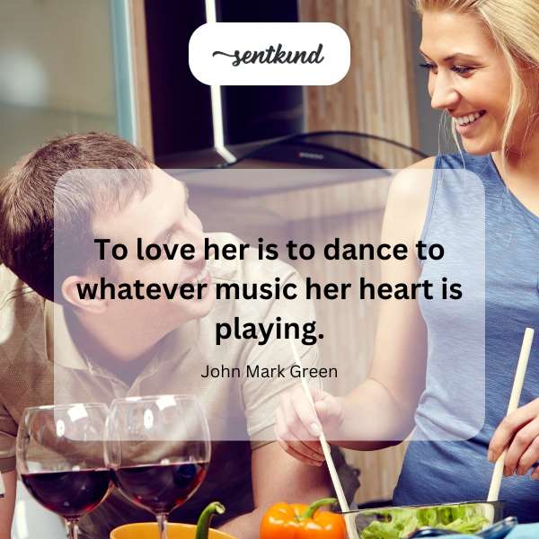 A couple is dancing closely, seemingly lost in their own world, surrounded by soft, dreamy lighting.
