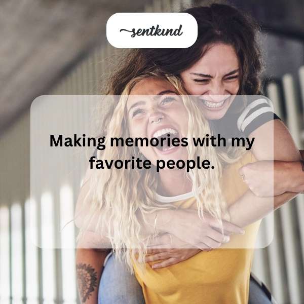 A group of diverse friends is laughing and hugging in a park during sunset, looking genuinely happy together.