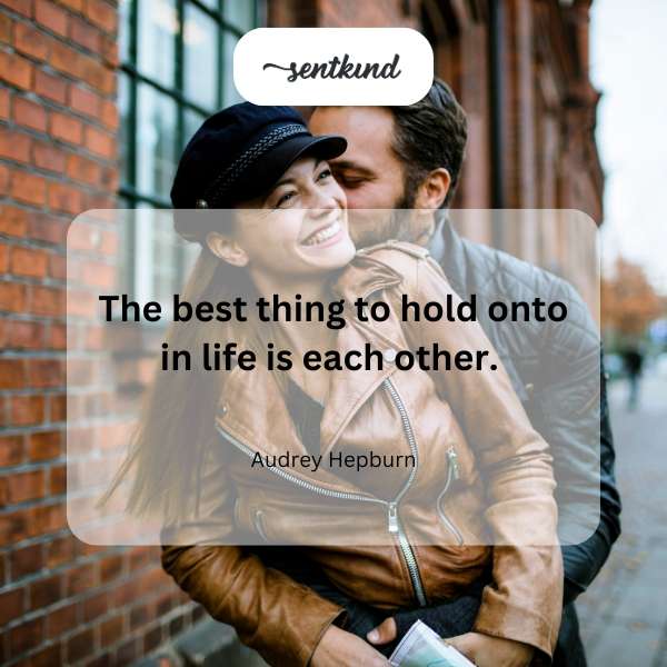 A close-up photo of two people holding hands.