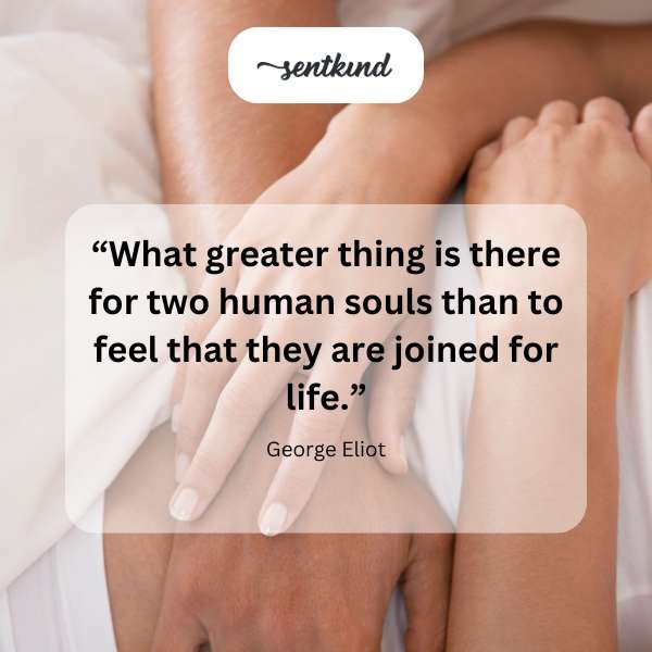 Two hands reach for each other against a soft, blurred background.