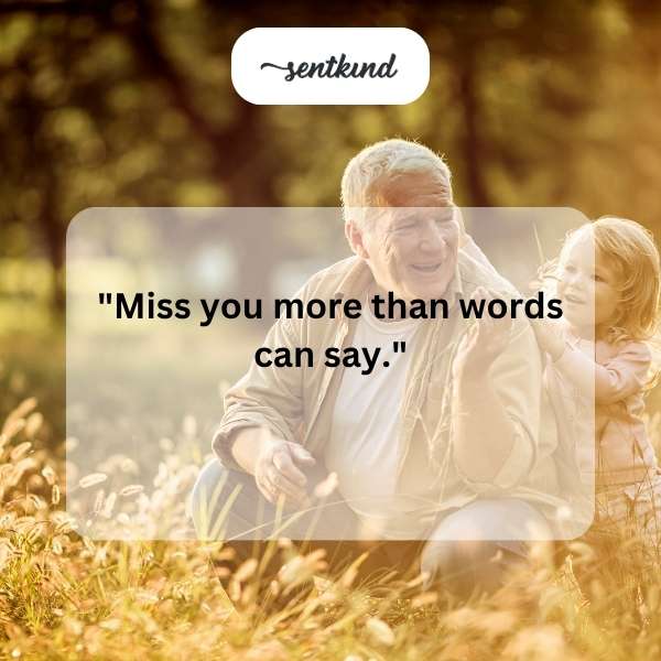 An elderly man is seen lovingly holding a young child in his arms.