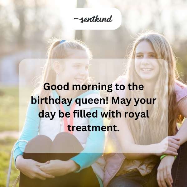 A woman wearing a crown smiles radiantly, holding a birthday cake.
