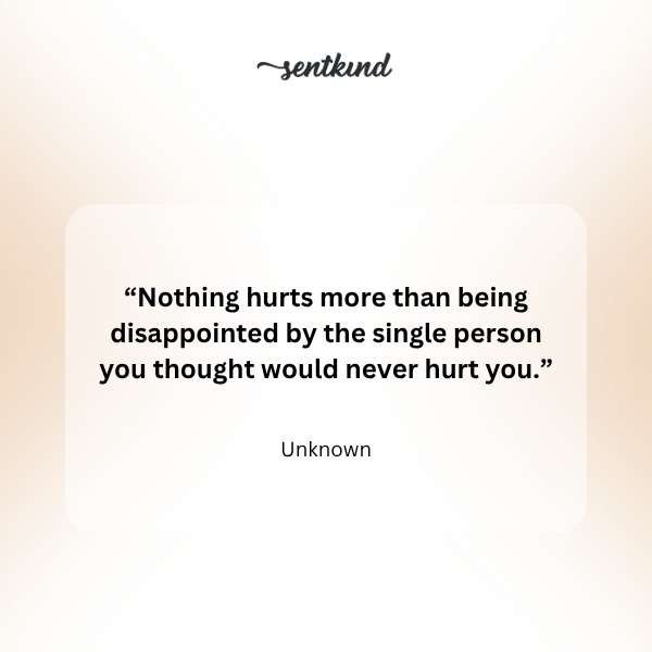 A solitary figure sits looking away from a distant, blurred family group, conveying feelings of isolation and pain.