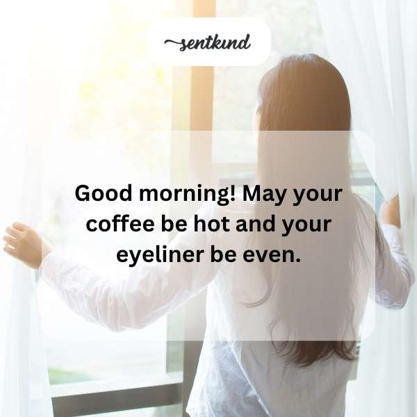 A smiling woman holds a hot coffee mug while showcasing her flawless winged eyeliner.
