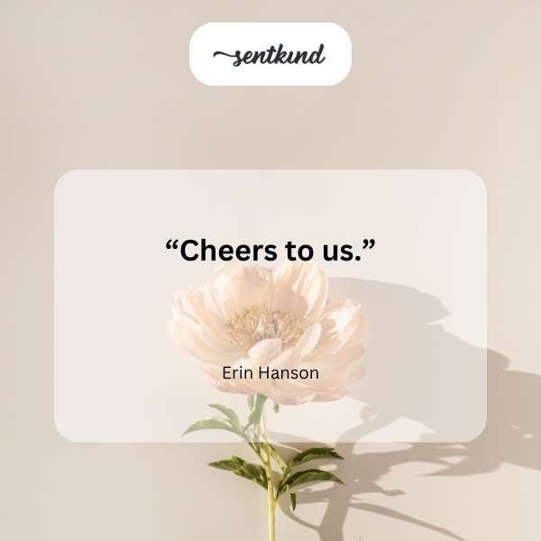 Two champagne glasses are raised in a celebratory toast.