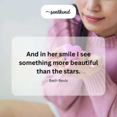 A person with a radiant smile is framed against a softly illuminated starry night sky.