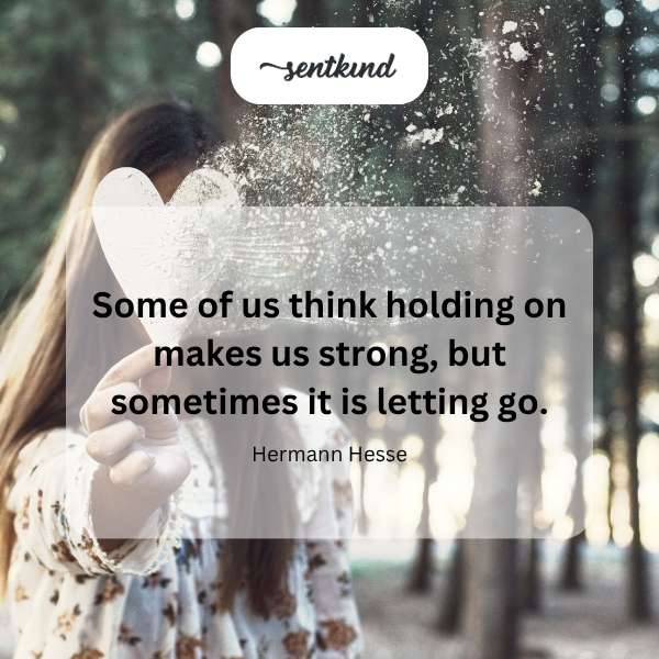A hand gently releases a white feather into the wind.
