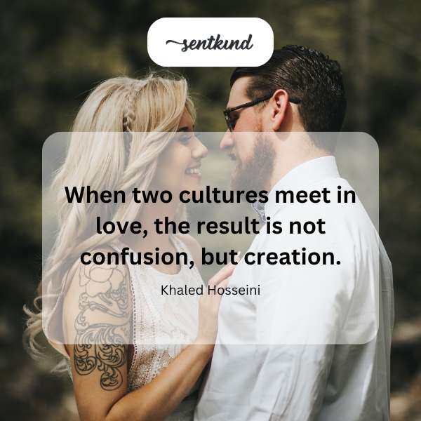 Two hands of different skin tones intertwine, symbolizing unity and connection.