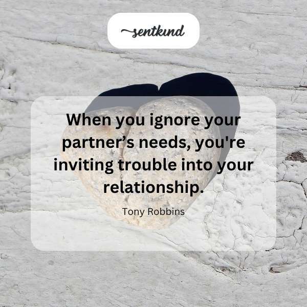 A couple sits back to back on a couch, appearing disconnected and upset.