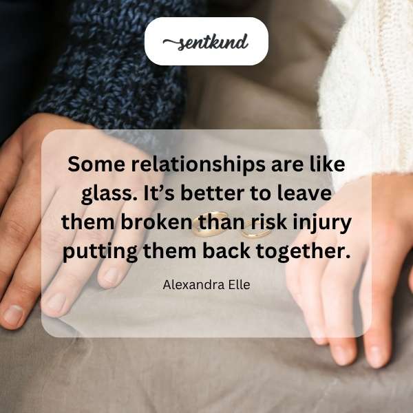 A shattered glass heart lies on a dark surface, reflecting light.