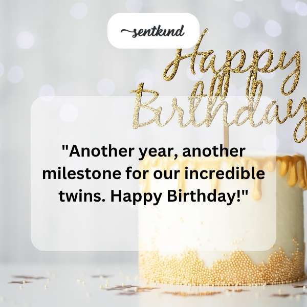 Two smiling children, presumably twins, stand side-by-side in party hats.