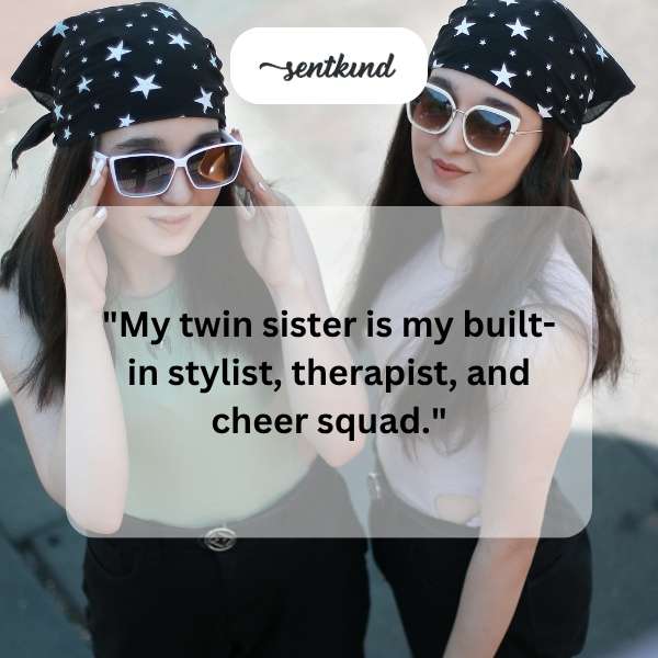 Two identical twin sisters are smiling and embracing, one holding a clothing rack.