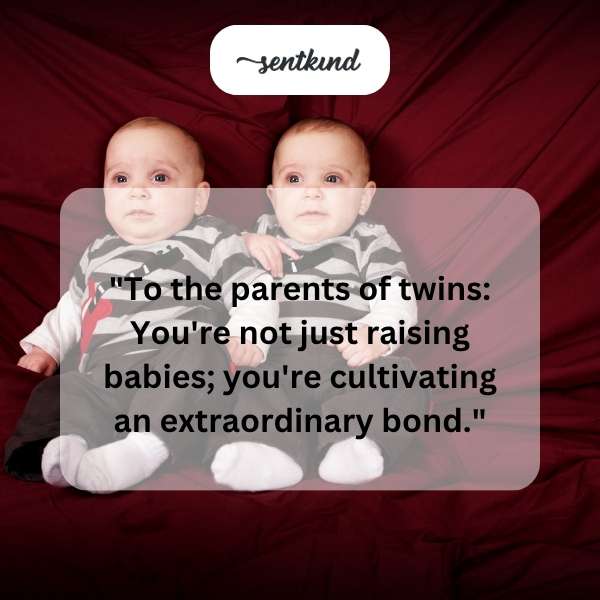 Two babies lying side-by-side, reaching for each other.