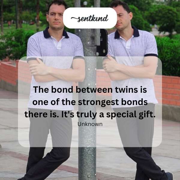 Two young identical twins are embracing each other tightly, symbolizing their close connection.