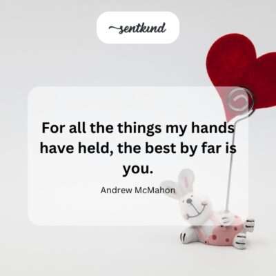 Close-up of a person's hands gently holding the small hands of a child.
