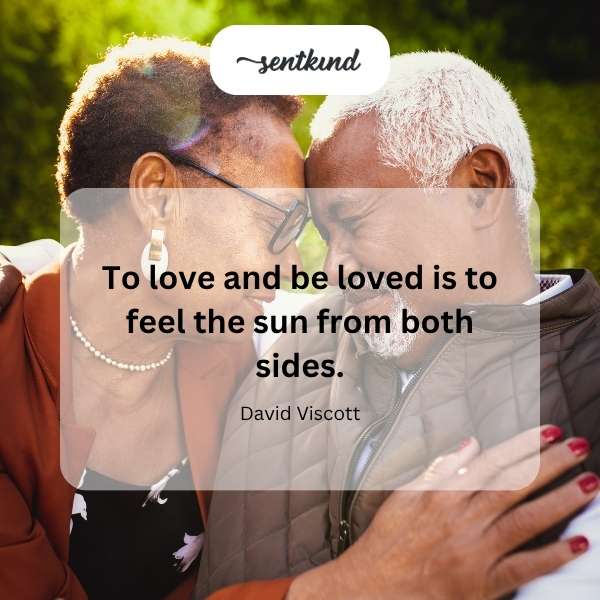 A person basks in sunlight with a loving embrace, representing warmth and affection.