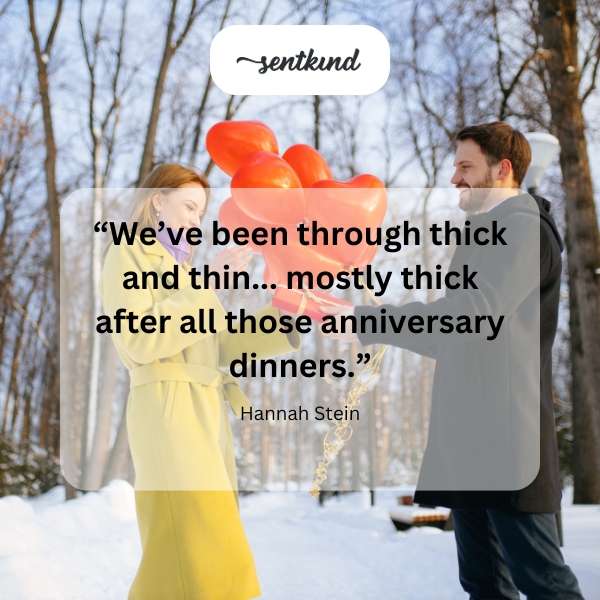 A couple laughs at a table overloaded with food.