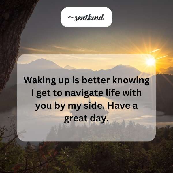 A couple is holding hands while watching the sunrise over a peaceful landscape.