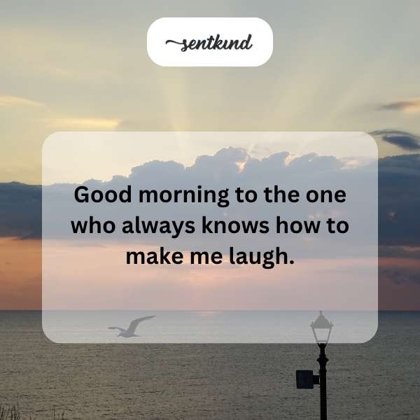 A person smiles brightly, holding a coffee mug.