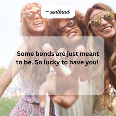 A group of friends laughing joyfully together in a sunlit park.