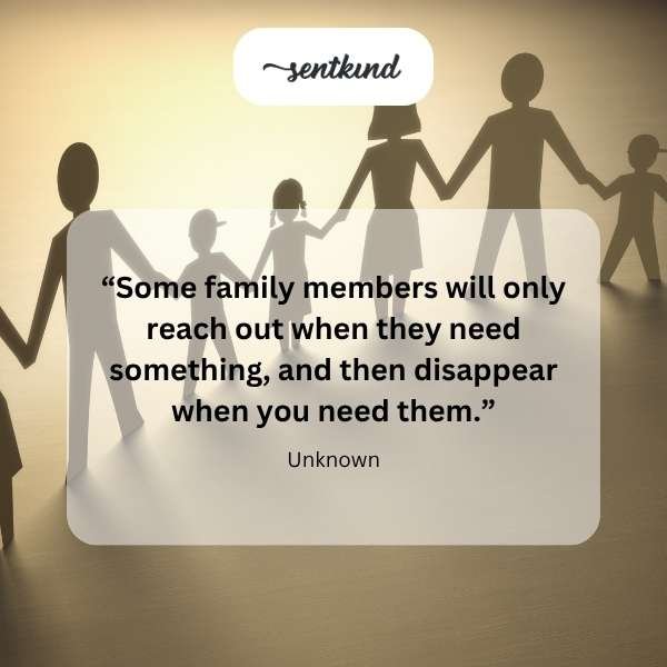 A lone figure sits at a dinner table slightly apart from a blurry group of family members, looking down with a somber expression.