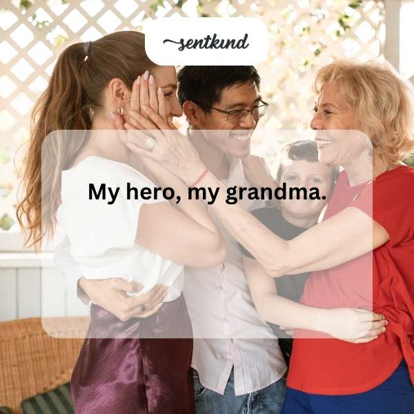 A smiling grandmother and her grandchild share a warm embrace indoors.