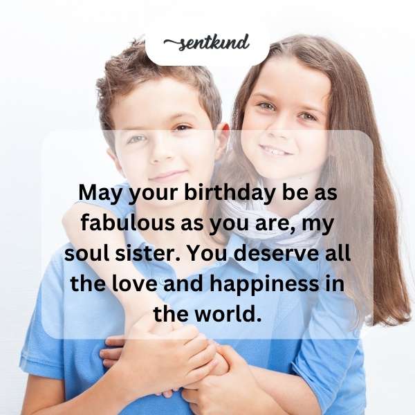 Two smiling women, resembling soul sisters, embrace warmly during a festive birthday celebration.