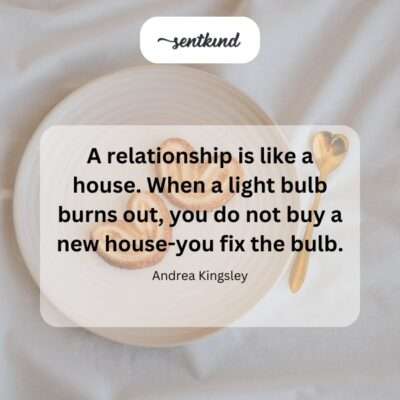 A hand carefully screws a new light bulb into a lamp, illuminating a cozy room in a home.