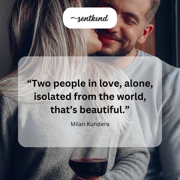 A couple embraces intimately, silhouetted against a soft, out-of-focus background.
