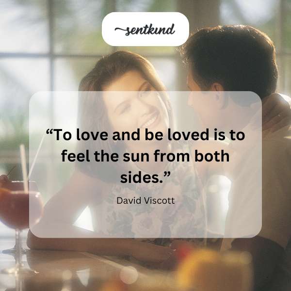Two people embracing in warm sunlight.