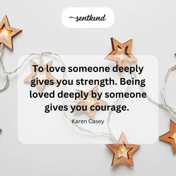 A heart glowing with light surrounded by protective hands.