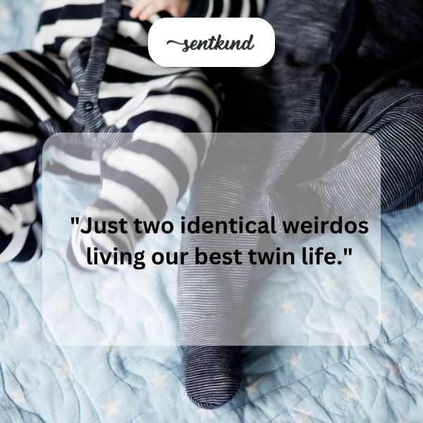Two identical twins are smiling and posing together in matching outfits.