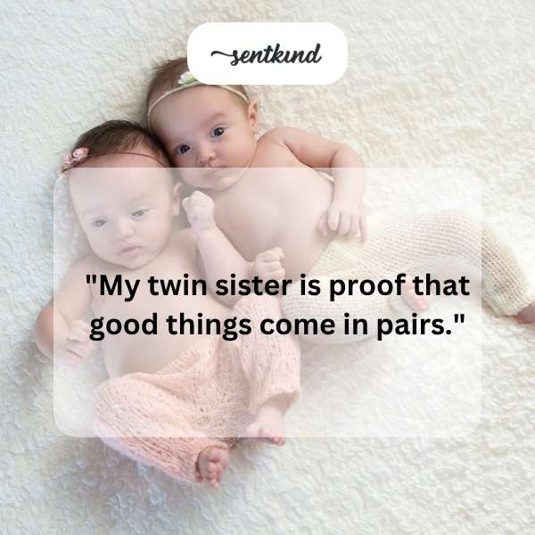 Two identical twin sisters are smiling and standing side-by-side.