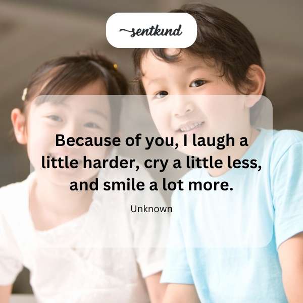 Two friends laughing together in a sunlit park, one wiping a tear of joy from her eye.