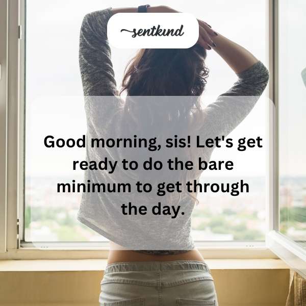 A person with messy hair sips coffee while looking tiredly at the camera, sitting on a bed in the early morning light.
