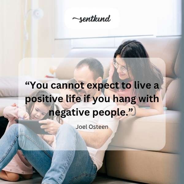 A person sits with their head in their hands, looking stressed and overwhelmed in a domestic setting, symbolizing the pressures of family relationships.