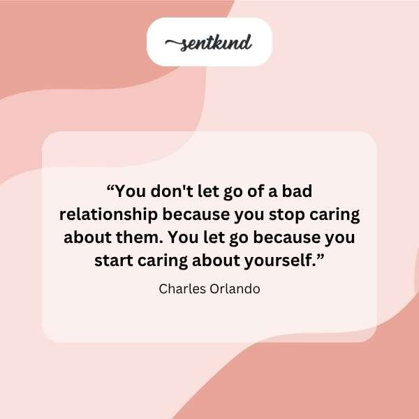 A single figure stands silhouetted against a vast sunset sky, arms open wide.