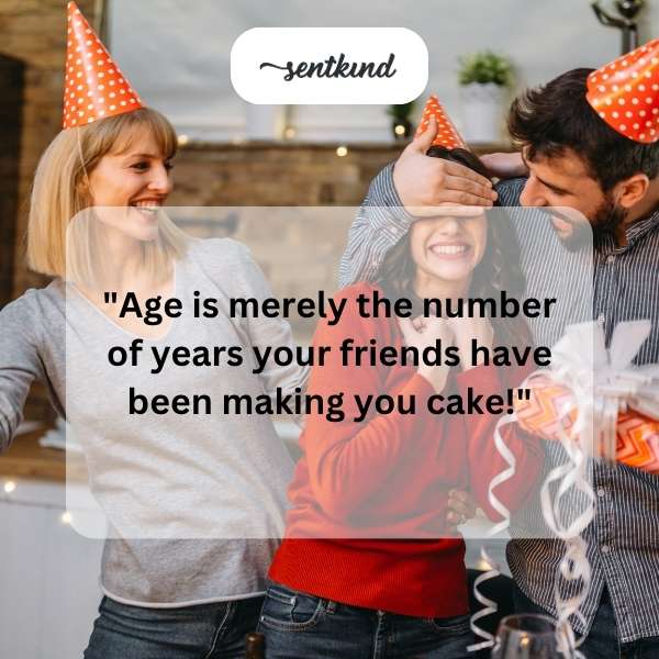 A group of diverse friends are laughing while presenting a birthday cake to someone.