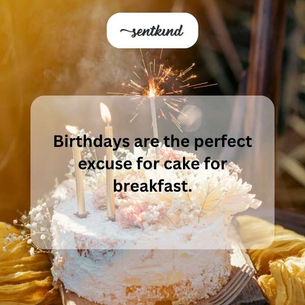 A frosted chocolate cake sits on a table with a serving knife beside it.