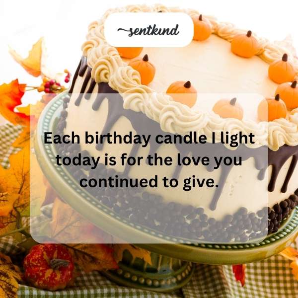 A woman smiles while holding a birthday cake with lit candles.