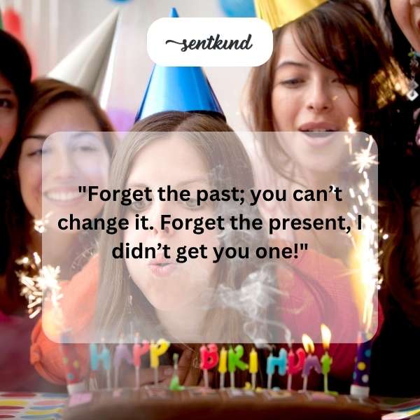 A person smiles while holding a multi-layered birthday cake decorated with candles.