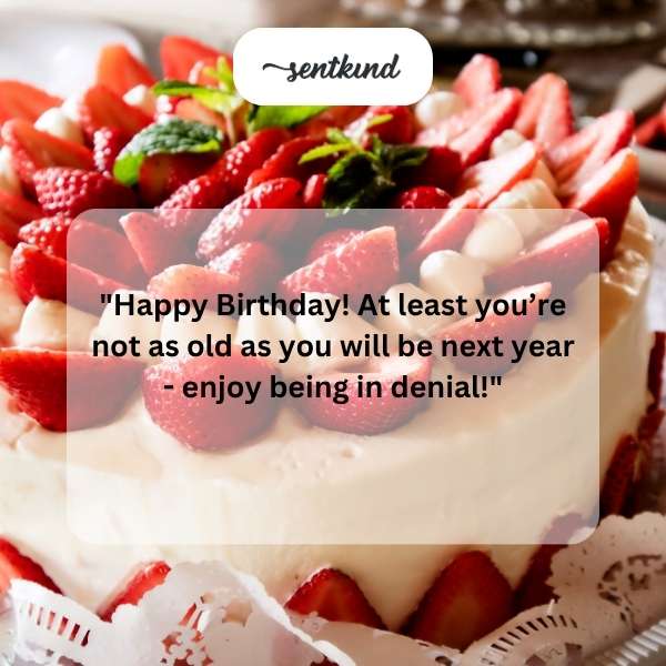 A birthday cake with lit candles sits before a smiling person.