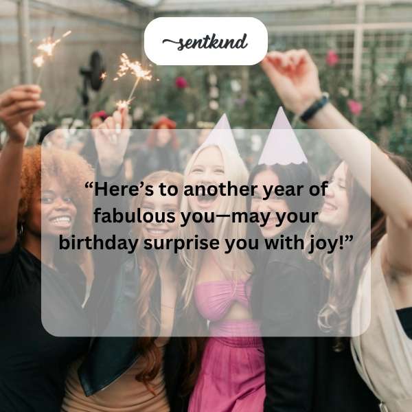 A smiling woman surrounded by birthday decorations.