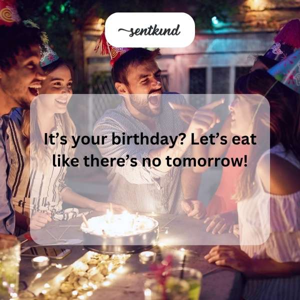 A person smiles while standing near a birthday cake.